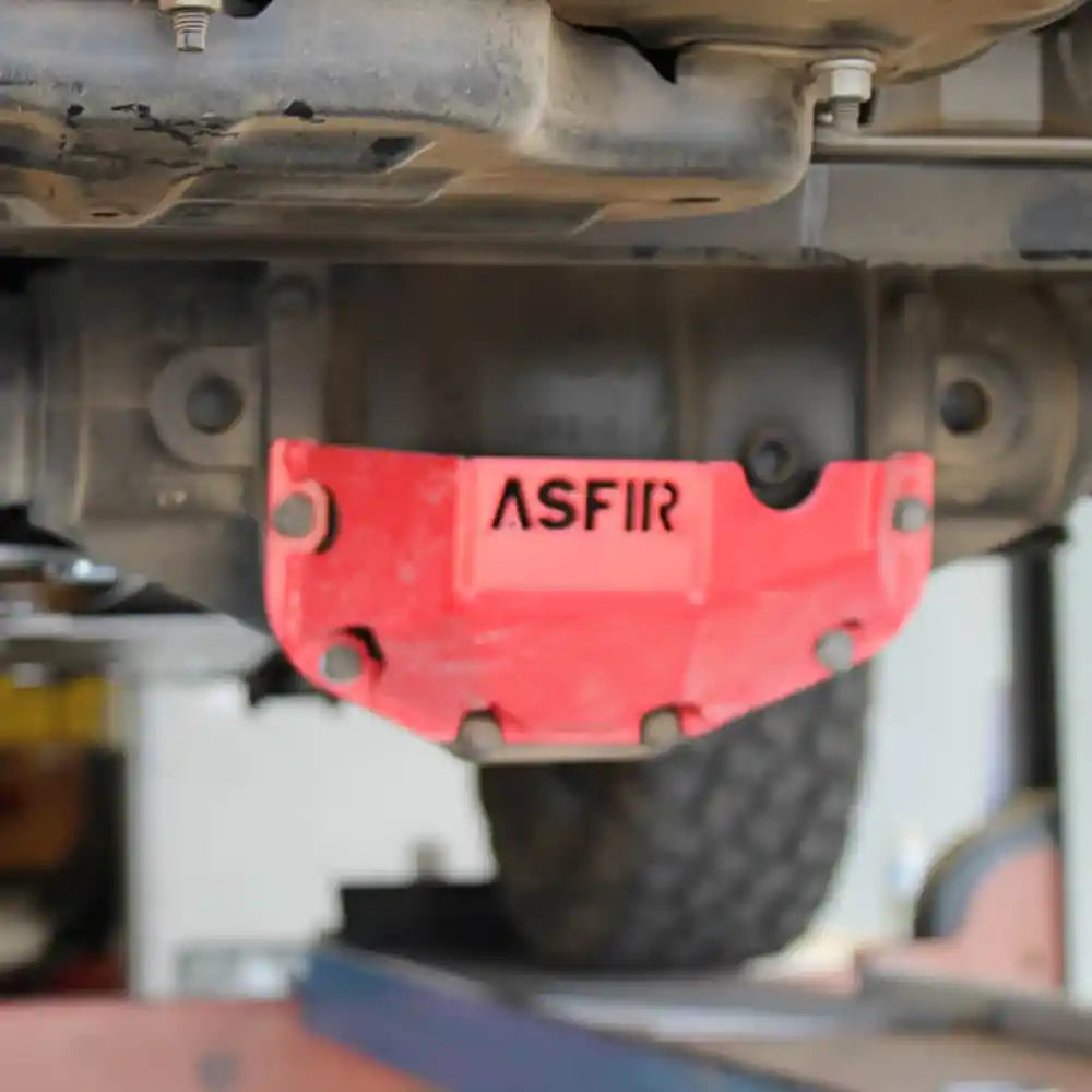 Installed Asfir front differential skid plate (red) on Jeep Gladiator JT, highlighting heavy-duty steel construction and precise fit around the axle.