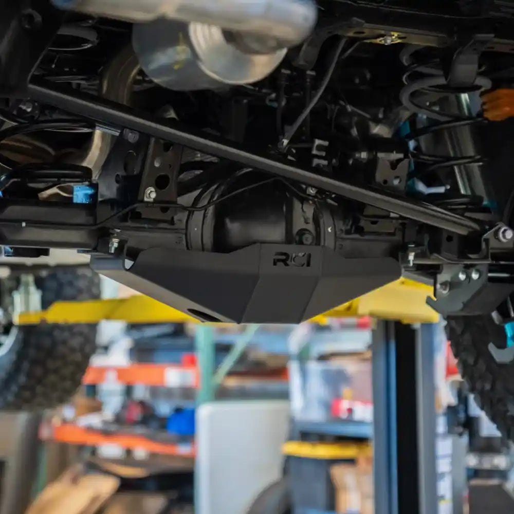 Installed RCI rear differential skid plate viewed from below on a lifted vehicle