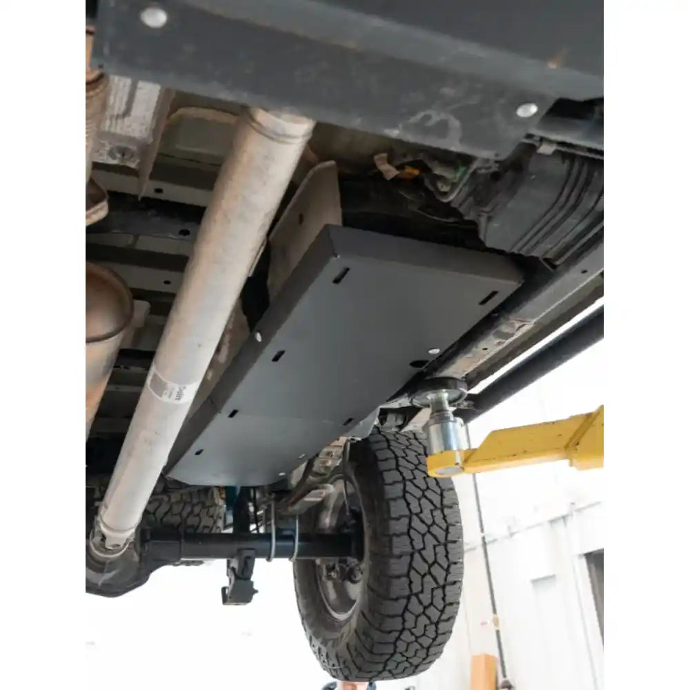 Installed RCI skid plate covering fuel tank from side underbody angle on lifted Colorado