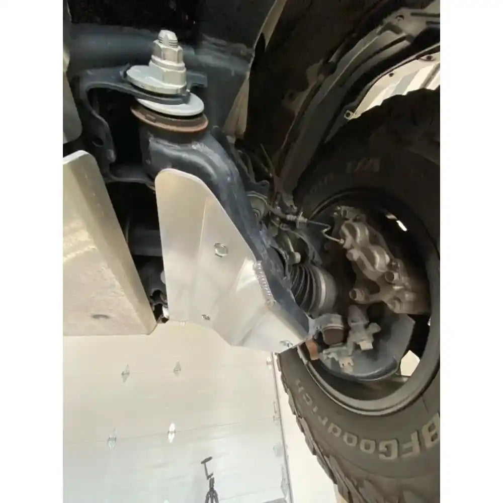 Installed black RCI A-arm guard protecting lower control arm