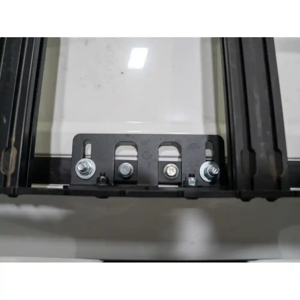 Interior view through Land Cruiser windshield showing black RCI rack crossbars overhead in studio