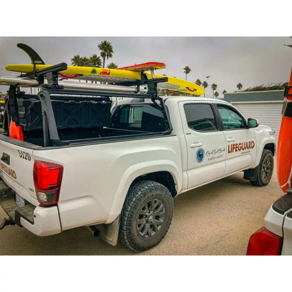 Leitner Designs ACS Forged bed rack mounted on white Toyota Tacoma with full overlanding gear loaded