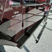Maroon G-Wagon parked indoors with prominent black rock sliders