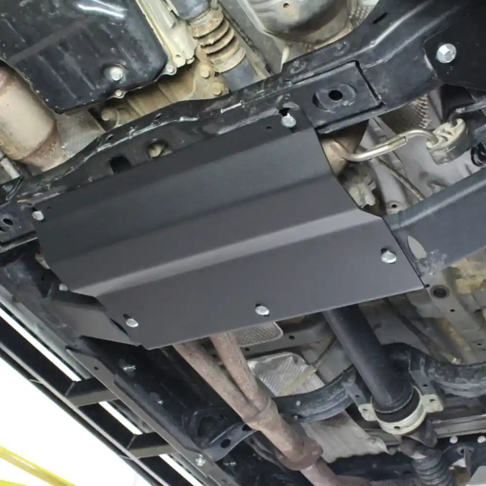 Matte black RCI skid plate secured to transfer case area