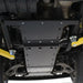 Mid-section transfer case skid plate installed with yellow suspension components visible