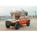 Orange off-road vehicle with expedition roof rack and cargo