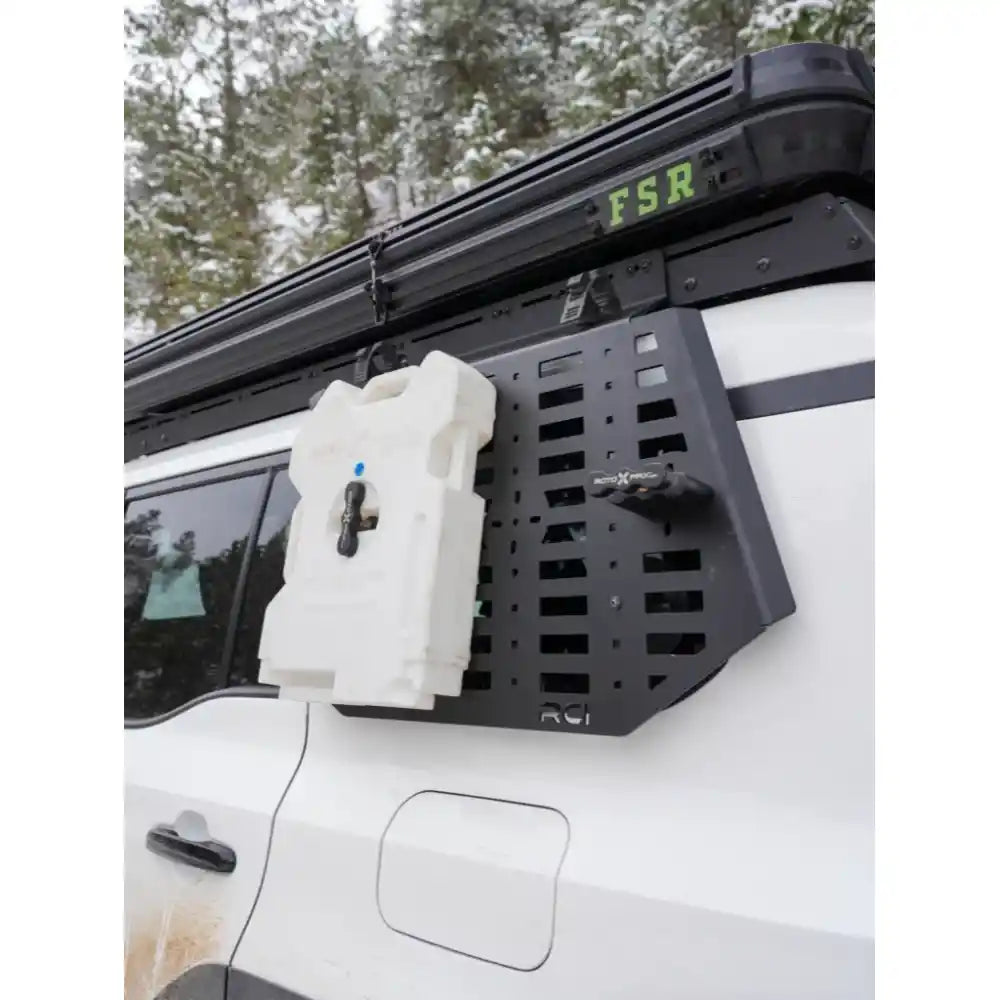 Pair of RCI Molle panels mounted on roof rack sides of dark 4Runner, off-road trail scene.