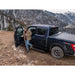 Person getting into a black truck in a mountainous area