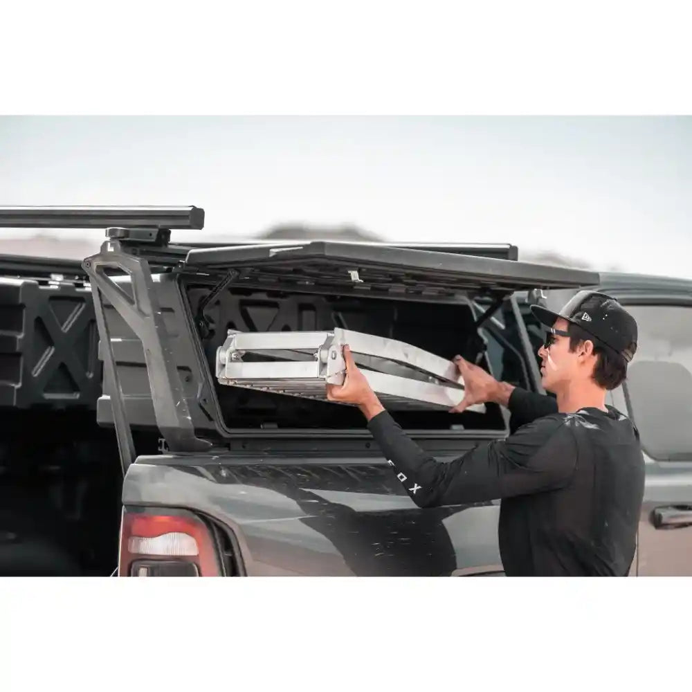 Person putting ladder in Leitner Designs ACS FORGED NDNS Bed Rack on Nissan