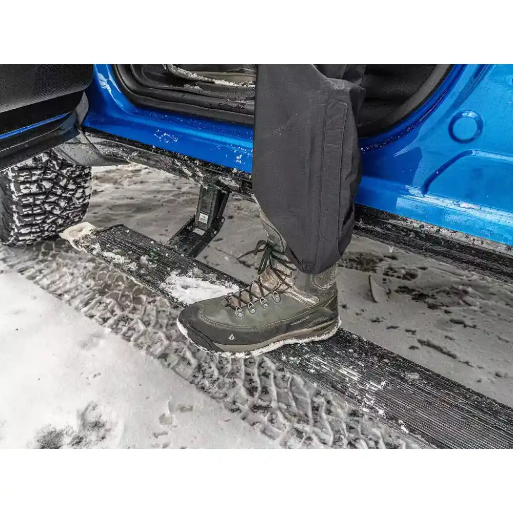 Person using a car step to enter a vehicle on a snowy day