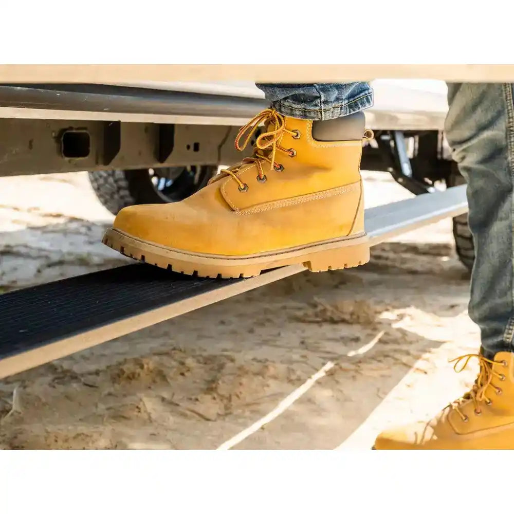 Person wearing yellow boots on a truck step sliders with a natural background