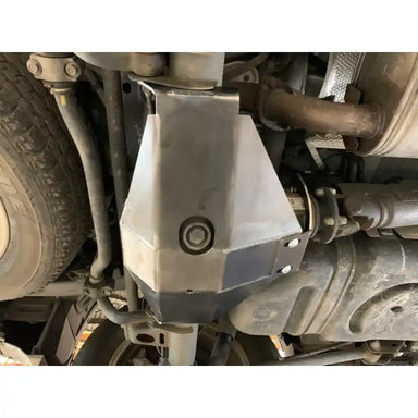 Polished stainless steel RCI diff skid plate mounted under vehicle