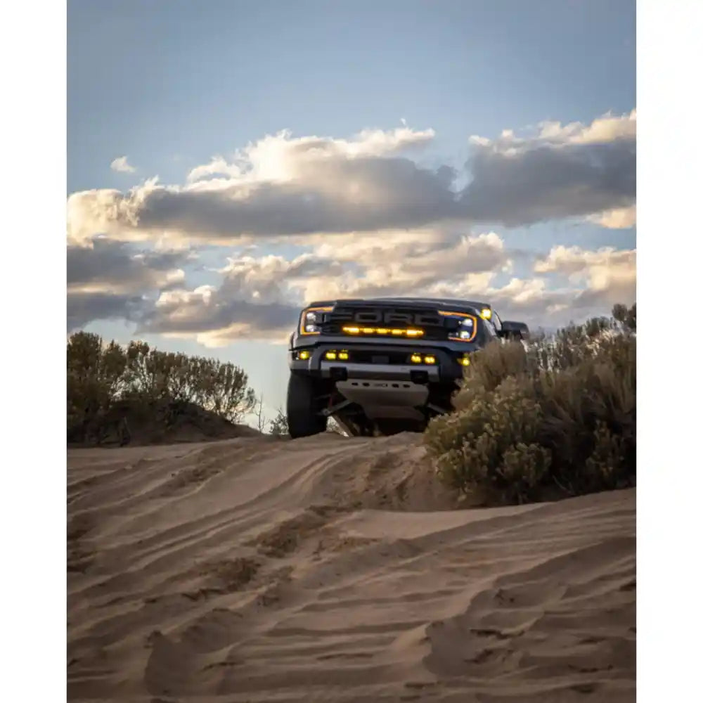 RCI-equipped Ranger off-roading on desert trail under cloudy sky.
