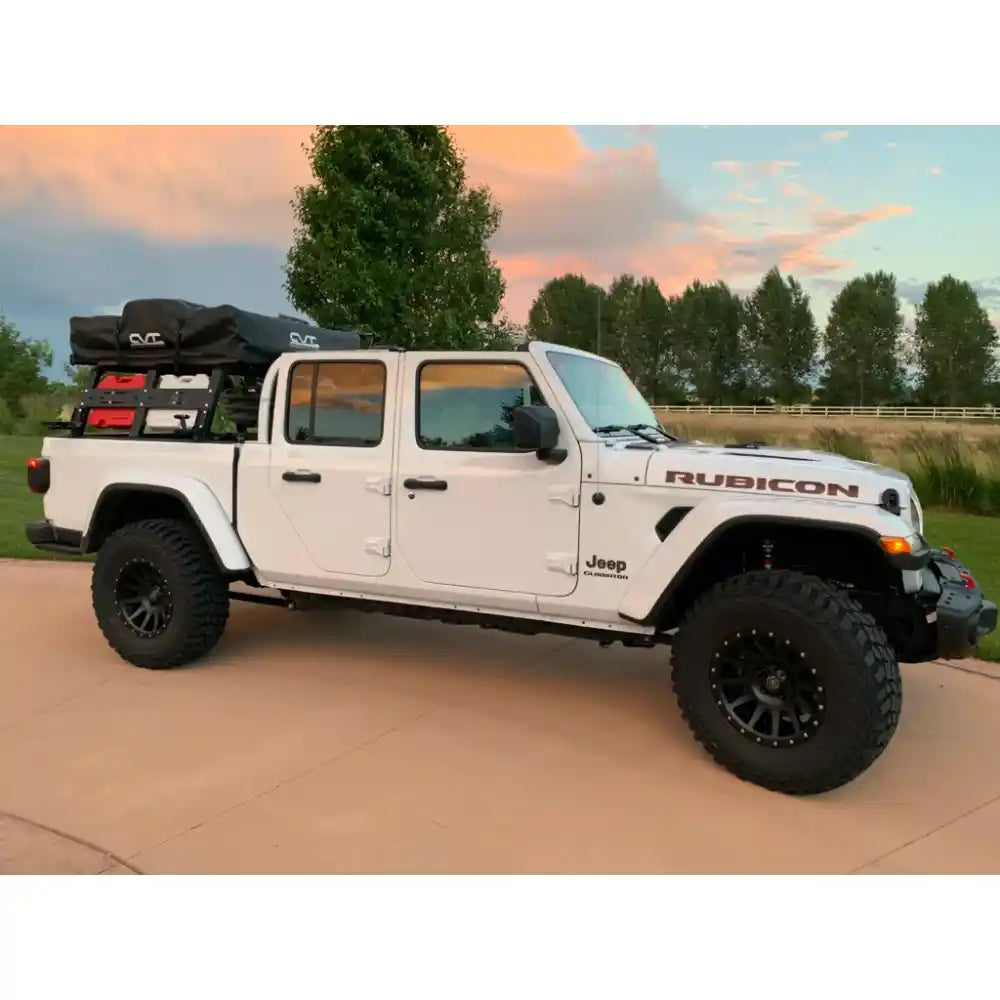 RCI Offroad bed rack carrying tent and jerry cans on Jeep at dusk