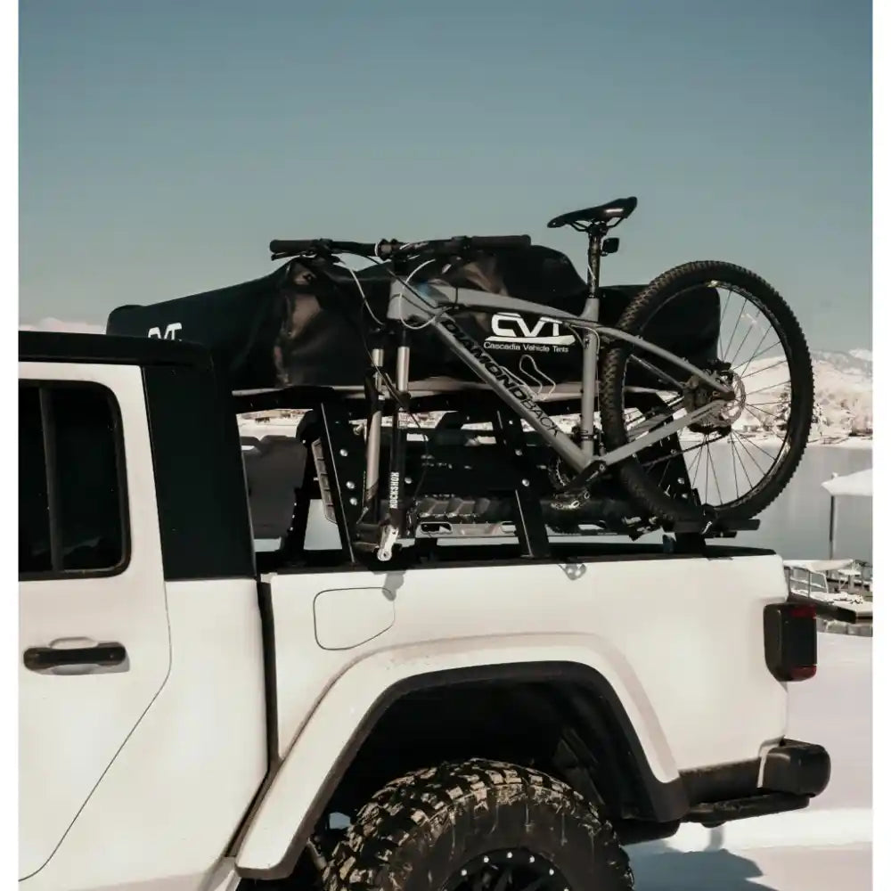 RCI Offroad rack carrying bike and black tent bag on winter Jeep pickup