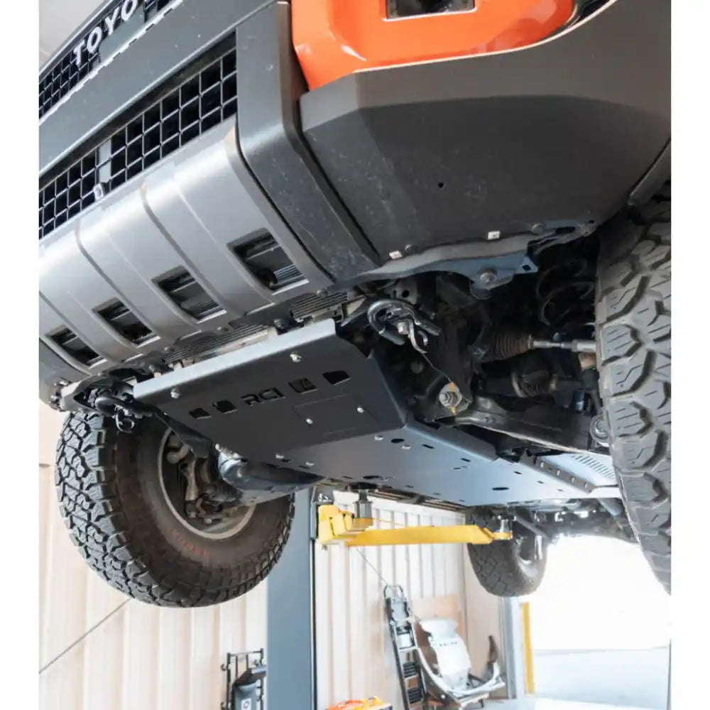 RCI heavy-duty engine skid plate installed on orange 2024+ Land Cruiser