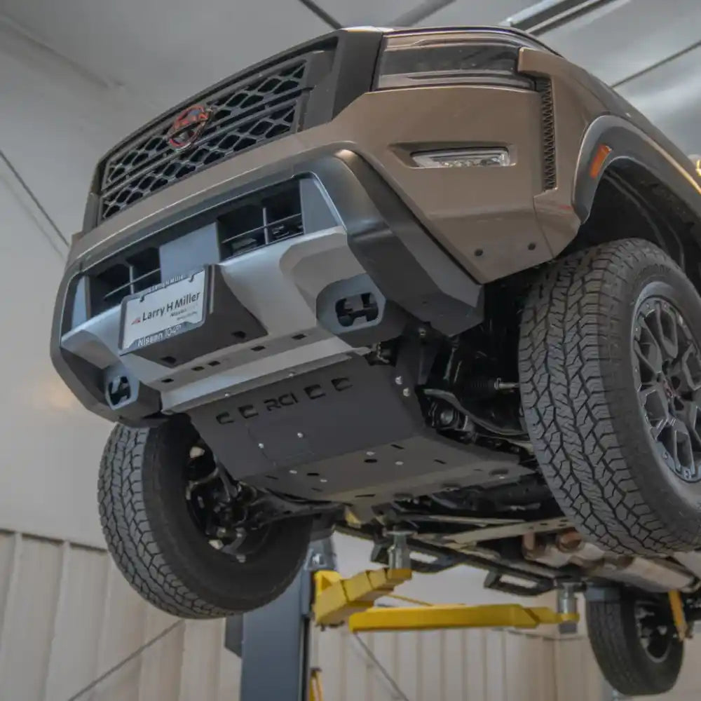 RCI skid plate protecting engine/transmission on tan Frontier