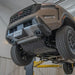 RCI skid plate protecting engine/transmission on tan Frontier