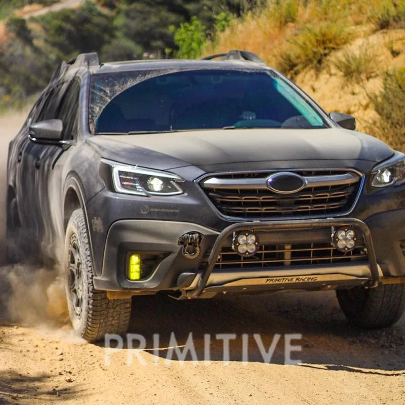 Gray outback driving on a dirt road with 'Primitive' Lip Skid Plate.