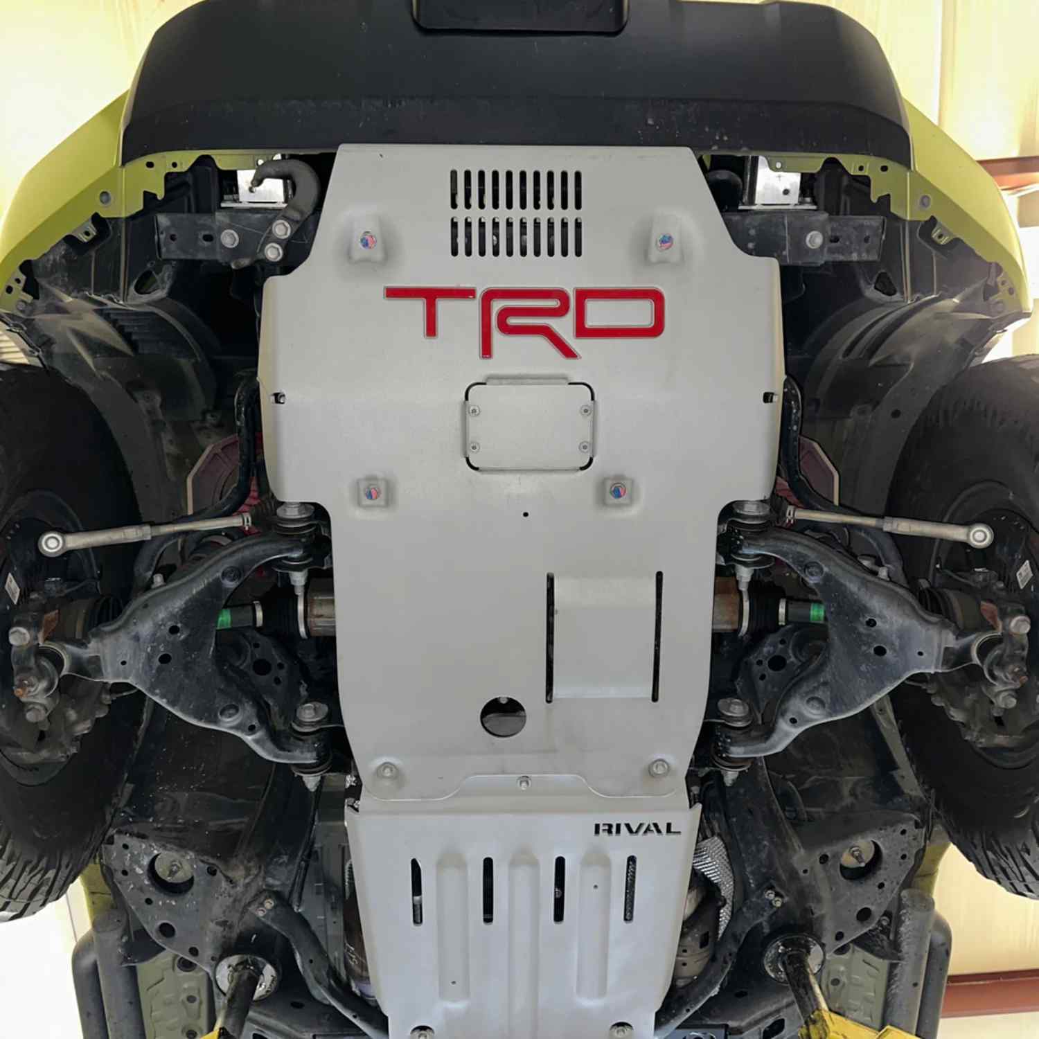 Underbody view of mounted RIVAL Aluminum Transmission and Transfer Case Skid Plate Tacoma