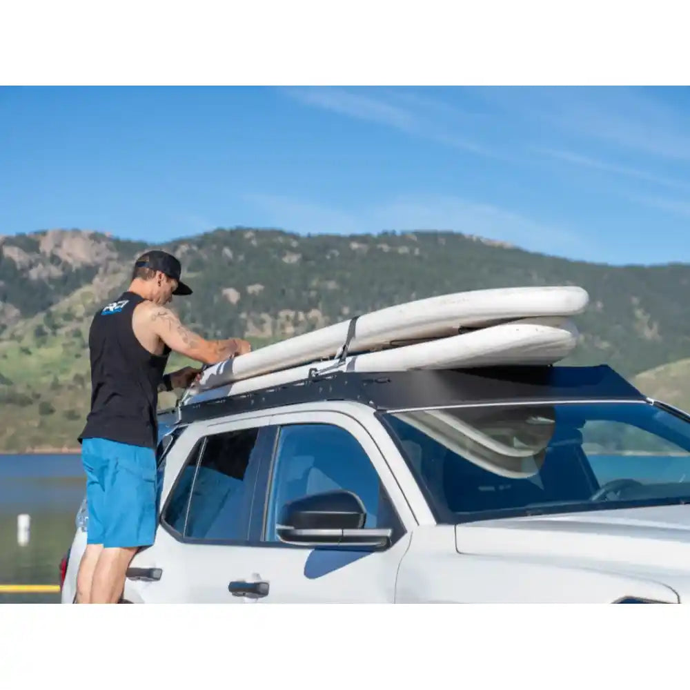 Rear angle of white 4Runner with RCI rack under soft clouds and open terrain