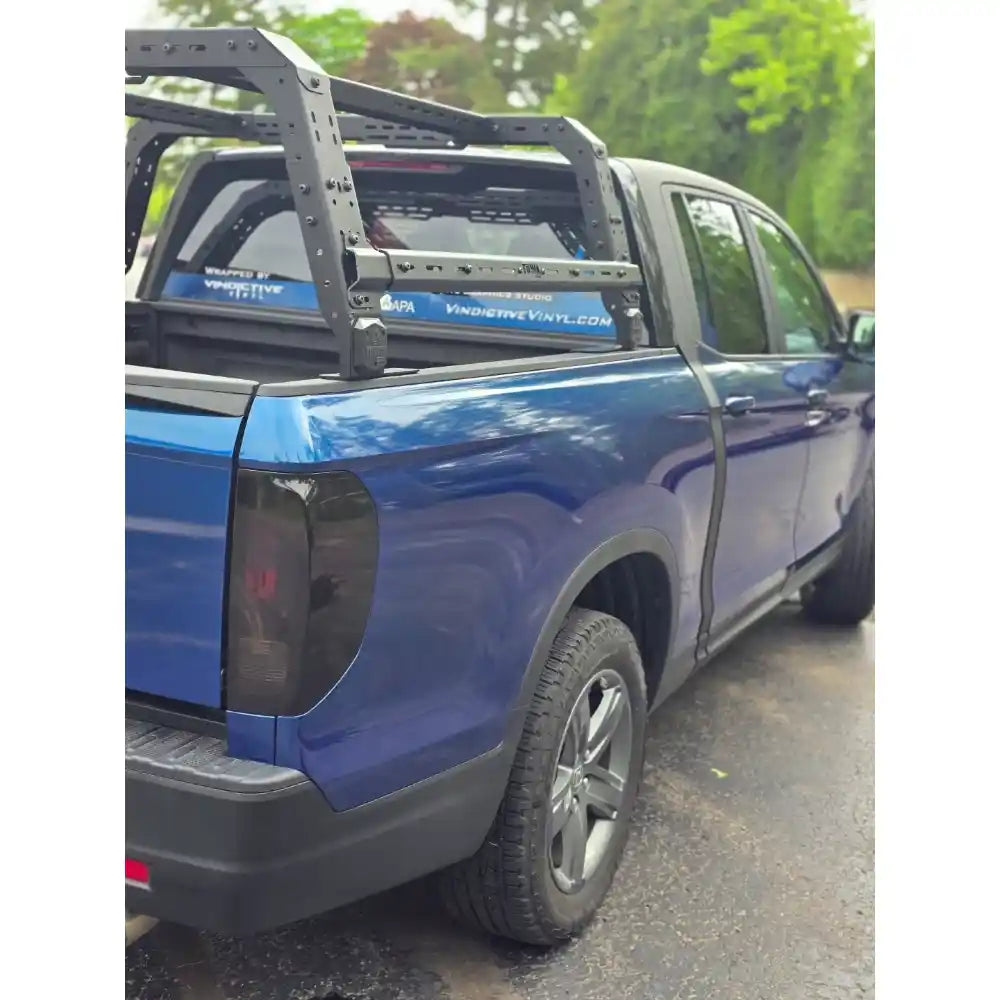 Rear view of blue Honda with mounted bed rack