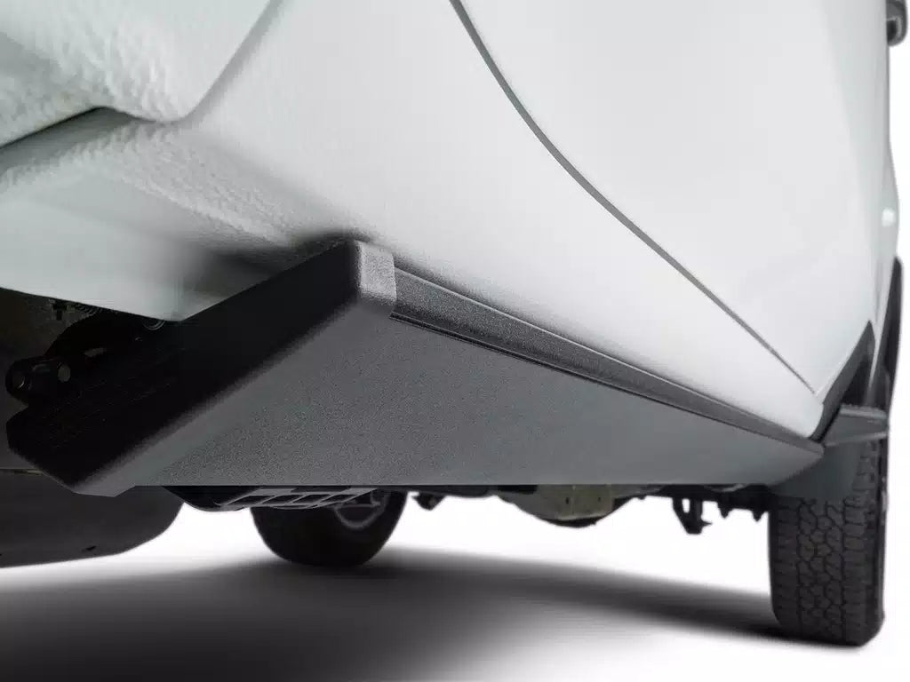 Retracted view of AMP Research PowerStep under the truck cab.