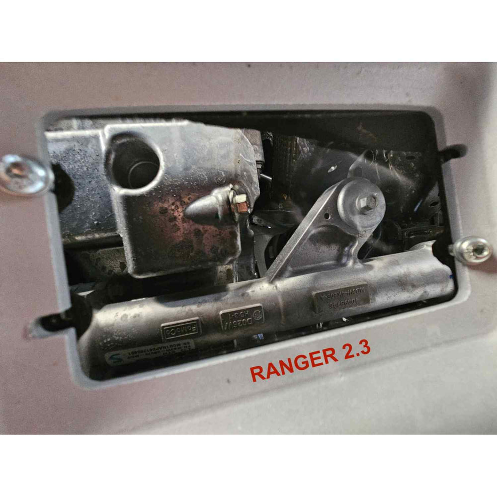 Engine skid plate opening with 'RANGER 2.3' text on a metallic surface