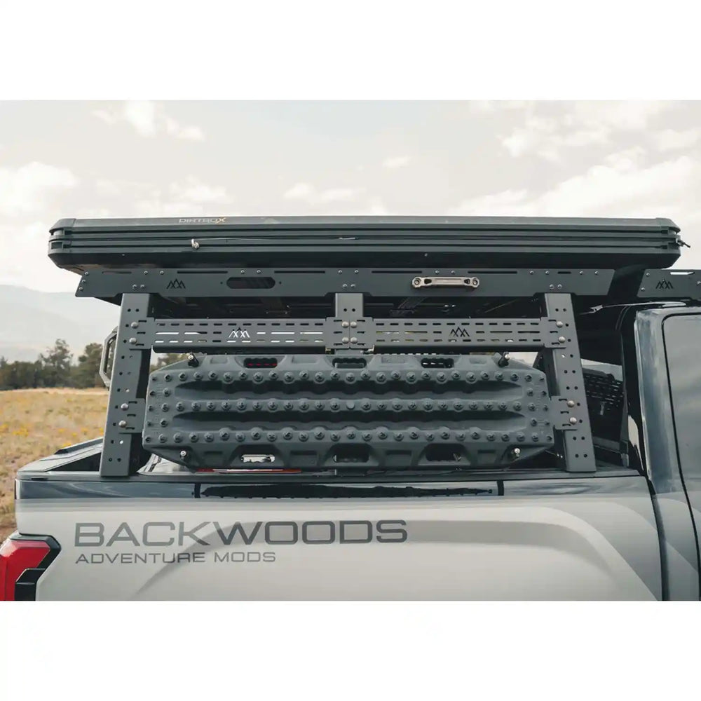 Roof rack system on a vehicle with 'Backwoods Adventure Mods' branding.