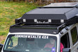 Roof rack system on a vehicle with 'TrailRax' branding, parked outdoors.