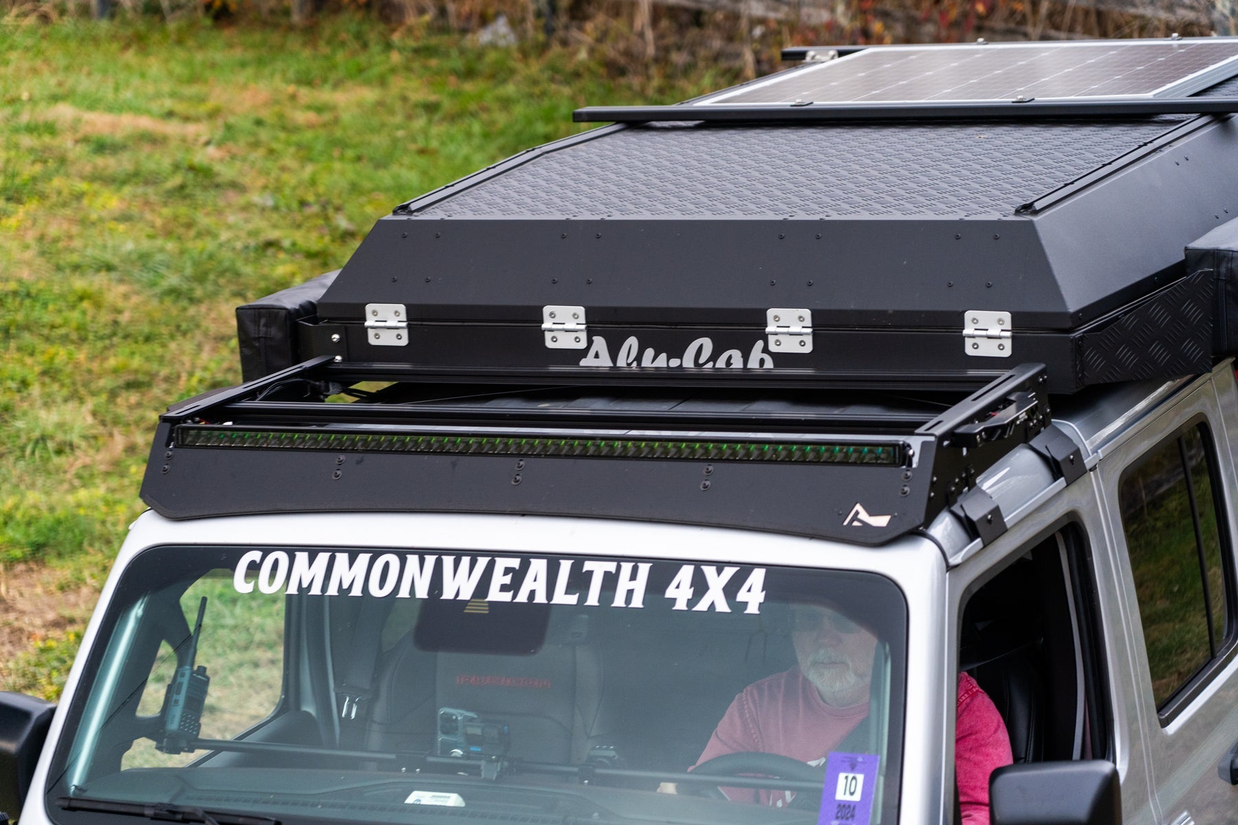 Roof rack system on a vehicle with 'TrailRax' branding, parked outdoors.