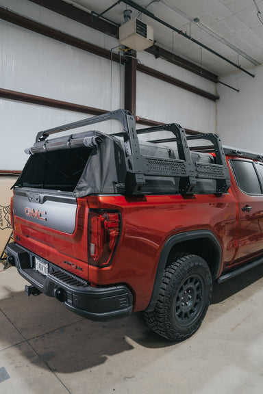 Rear view of the mounted bed rack with soft top on red GMC