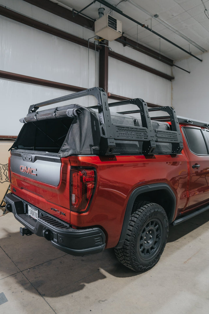 Rear view of the mounted bed rack with soft top on red GMC