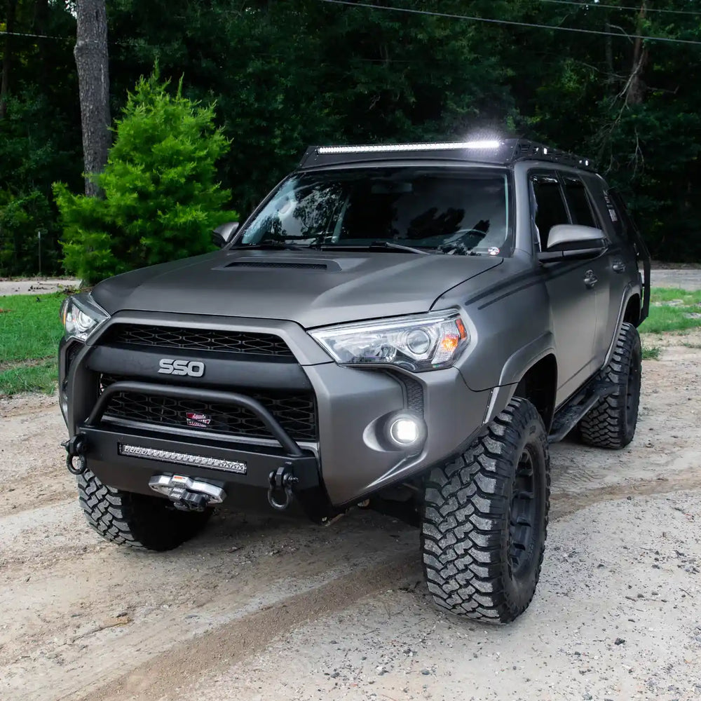 Gray 4Runner with SSO rock sliders off-road modifications on a dirt road