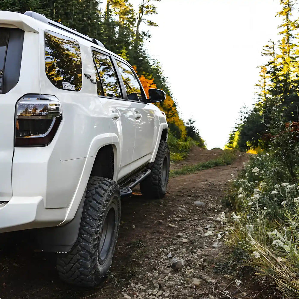 rear angled view of white 4Runner to show the look of Southern style rock sliders bolt on.