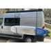 Promaster with a surfboard attached to a rack on the back