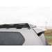 Side detail of black RCI rack crossbars and side rails secured to GX460 roof under cloudy sky