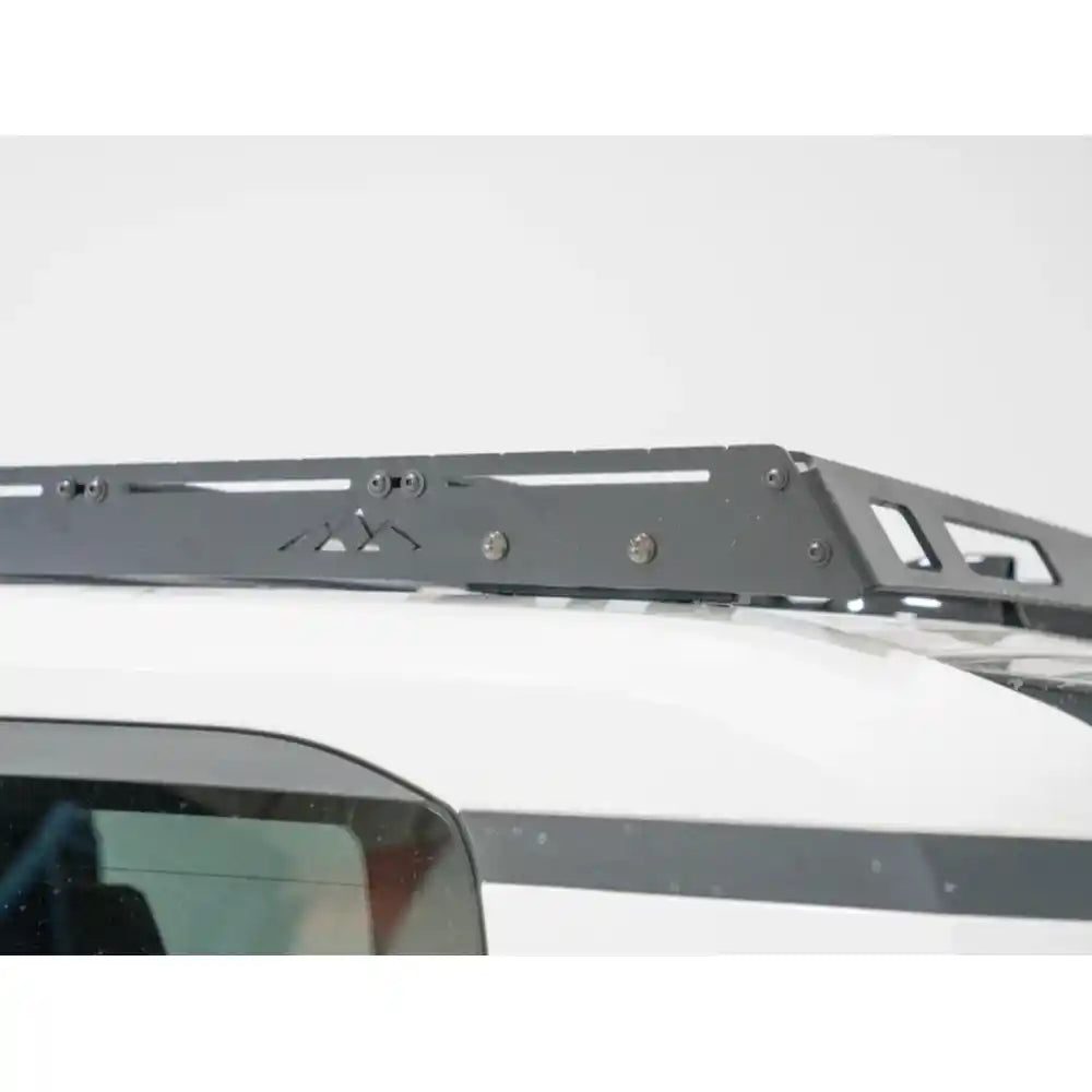 Side detail of black RCI rack side panel and branding on white Land Cruiser roof