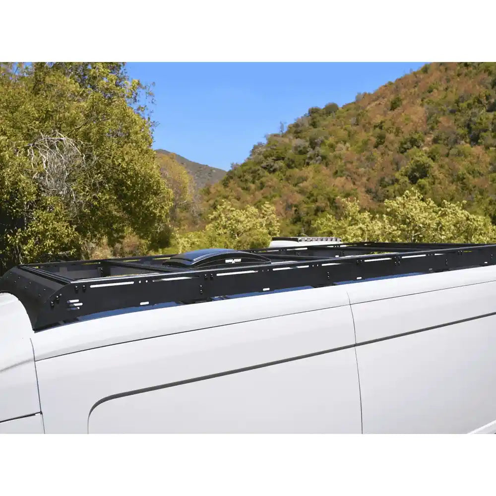 Side view of White Top Adventures roof rack mounted on Transit.
