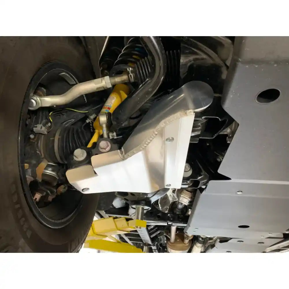 Side view of silver RCI A-arm skid plate on lifted Tundra