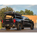 Black GMC truck with a rooftop storage box on a bed rack in an outdoor setting