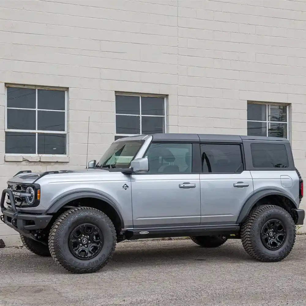 Silver Bronco off-road Rock Slide protection on road