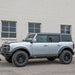 Silver Bronco off-road Rock Slide protection on road