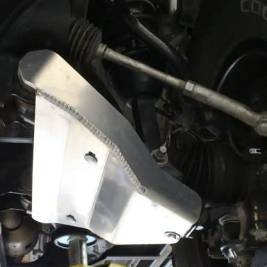 Silver RCI A-arm skid plate installed on lower control arm