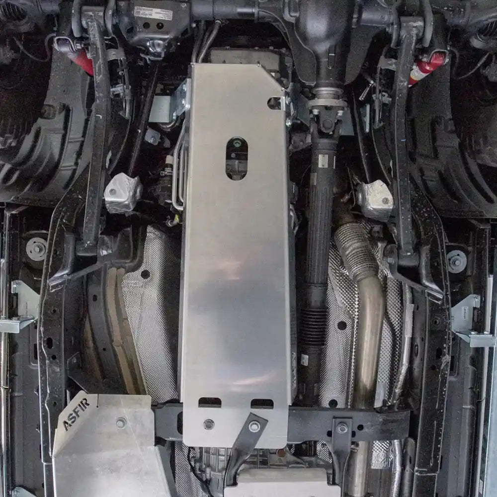 Silver transmission crossmember skid plate installed on Wrangler JL