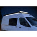 White van with a roof light under a starry night sky