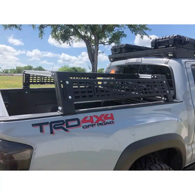 TRD 4x4 off-road truck with a bed rack on a clear day.