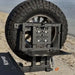 Tire carrier system attached to a Tundra tire with a blurred natural background