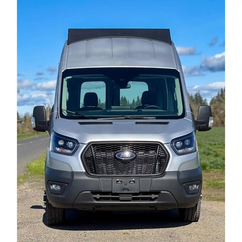 Front view of roof rack mounted on Ford van  with a blue sky and trees in the background