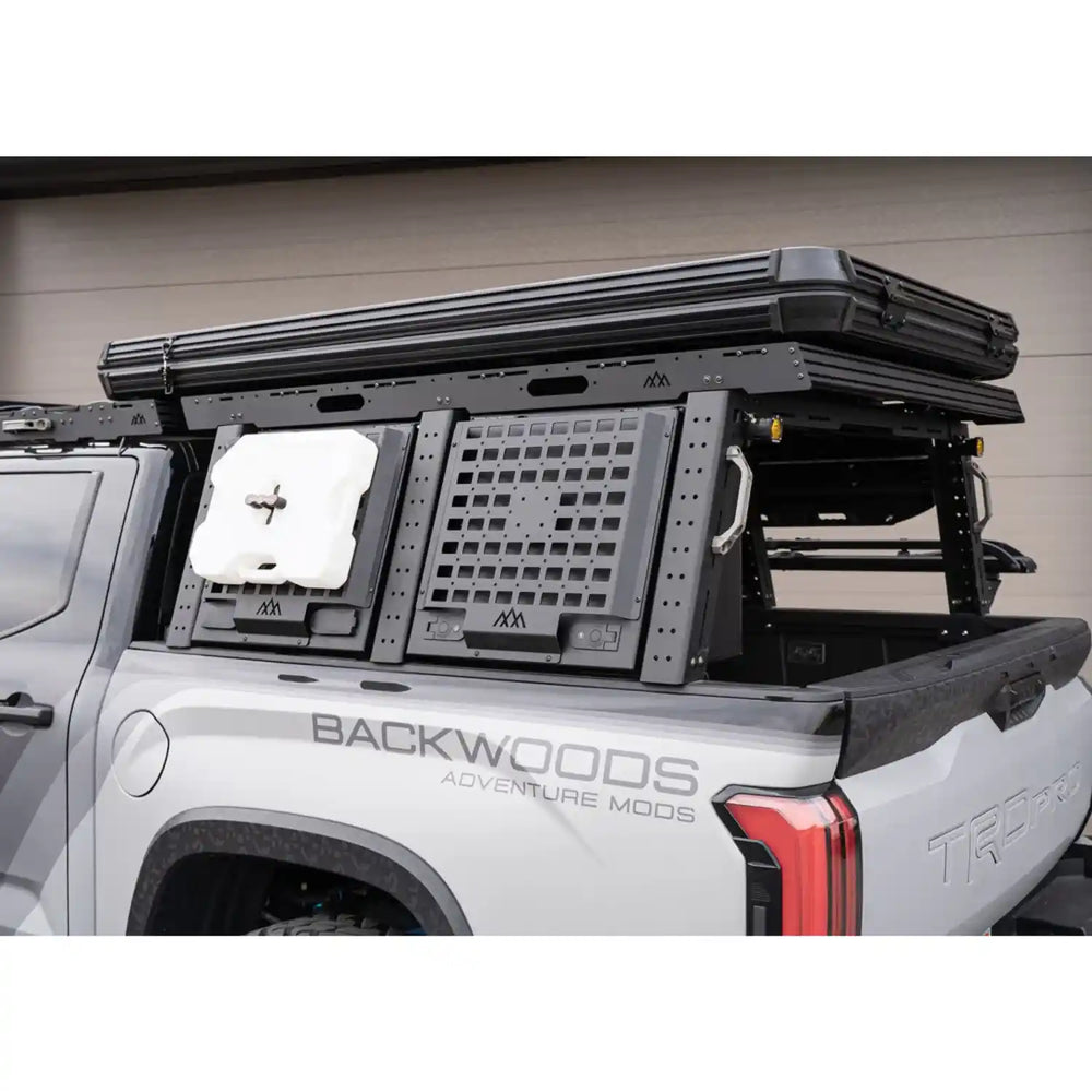 Truck bed with modular Rack system and 'Backwoods Adventure Mods' branding.